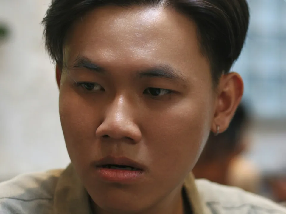 Man with a short side-parted Ivy League style haircut
